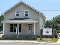 a house with a sign in front of it