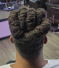 a man with dreadlocks in a salon